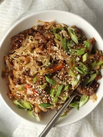 Blackstone Egg Roll in a Bowl with green onions and sesame seeds.