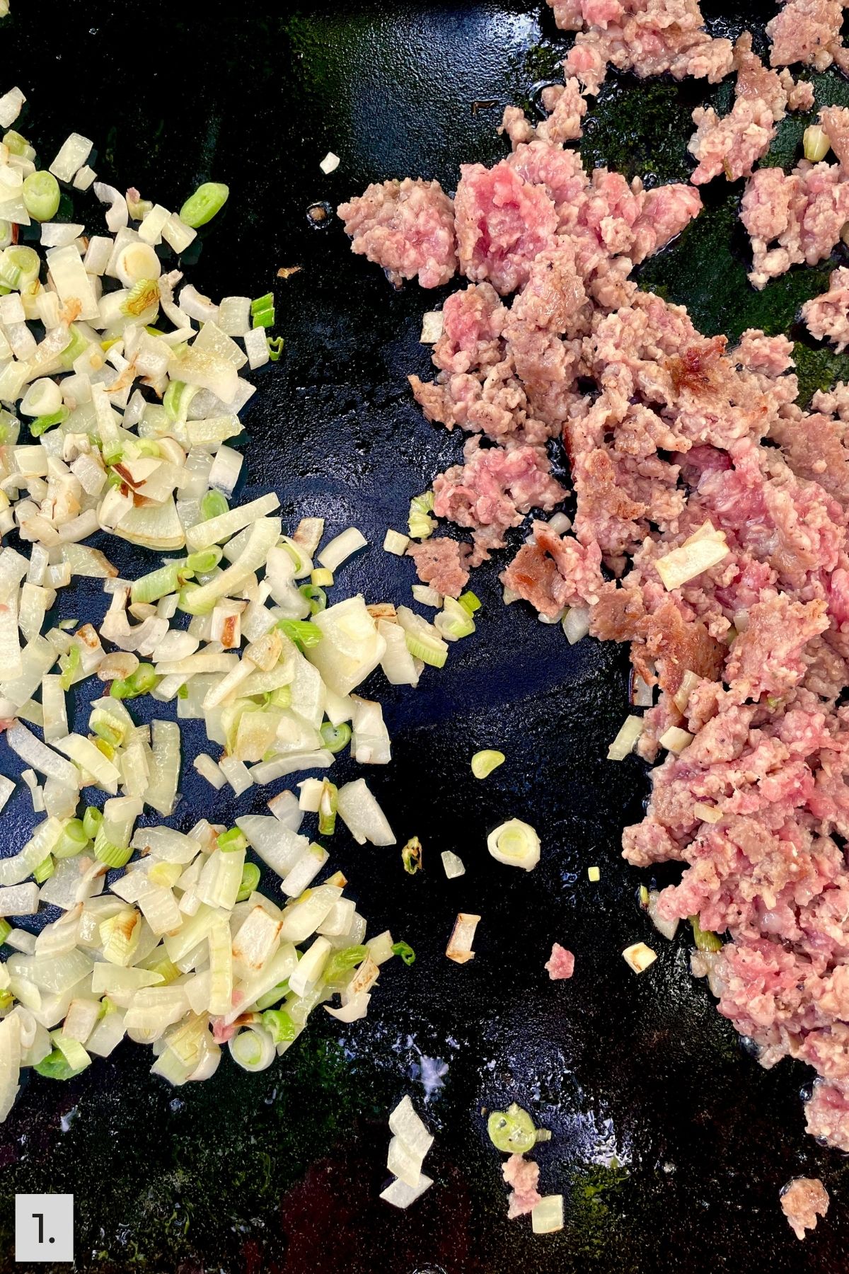 Pork sausage and onions being cooked on the Blackstone.