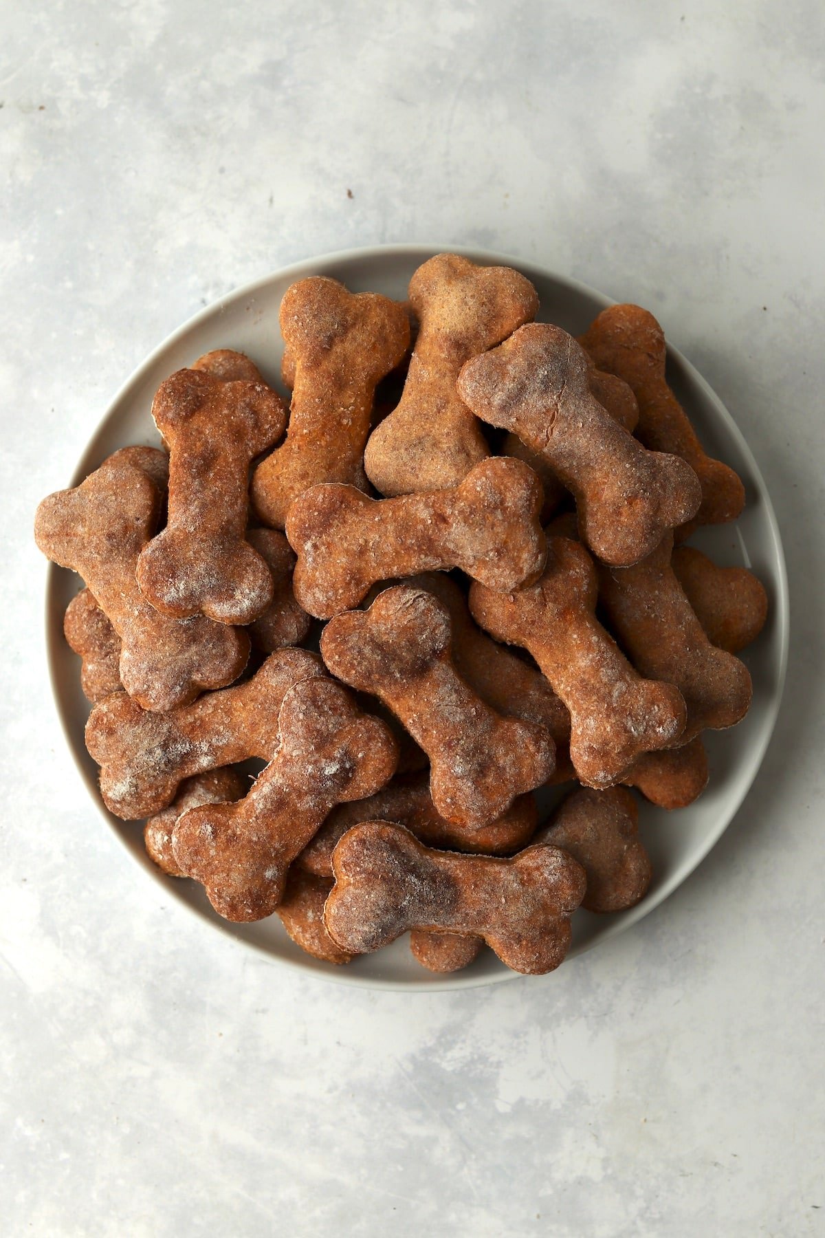 Plate of bone shaped sweet potato dog treats.