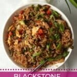 Bowl of Blackstone Veggie Fried Rice tossed with a stir fry sauce.