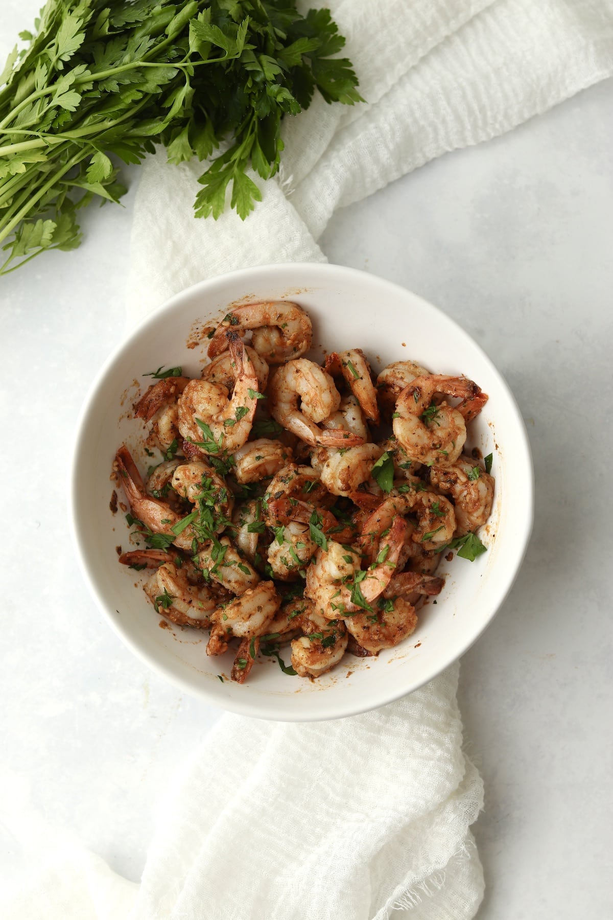 Blackstone cajun shrimp in a bowl with fresh parsley.