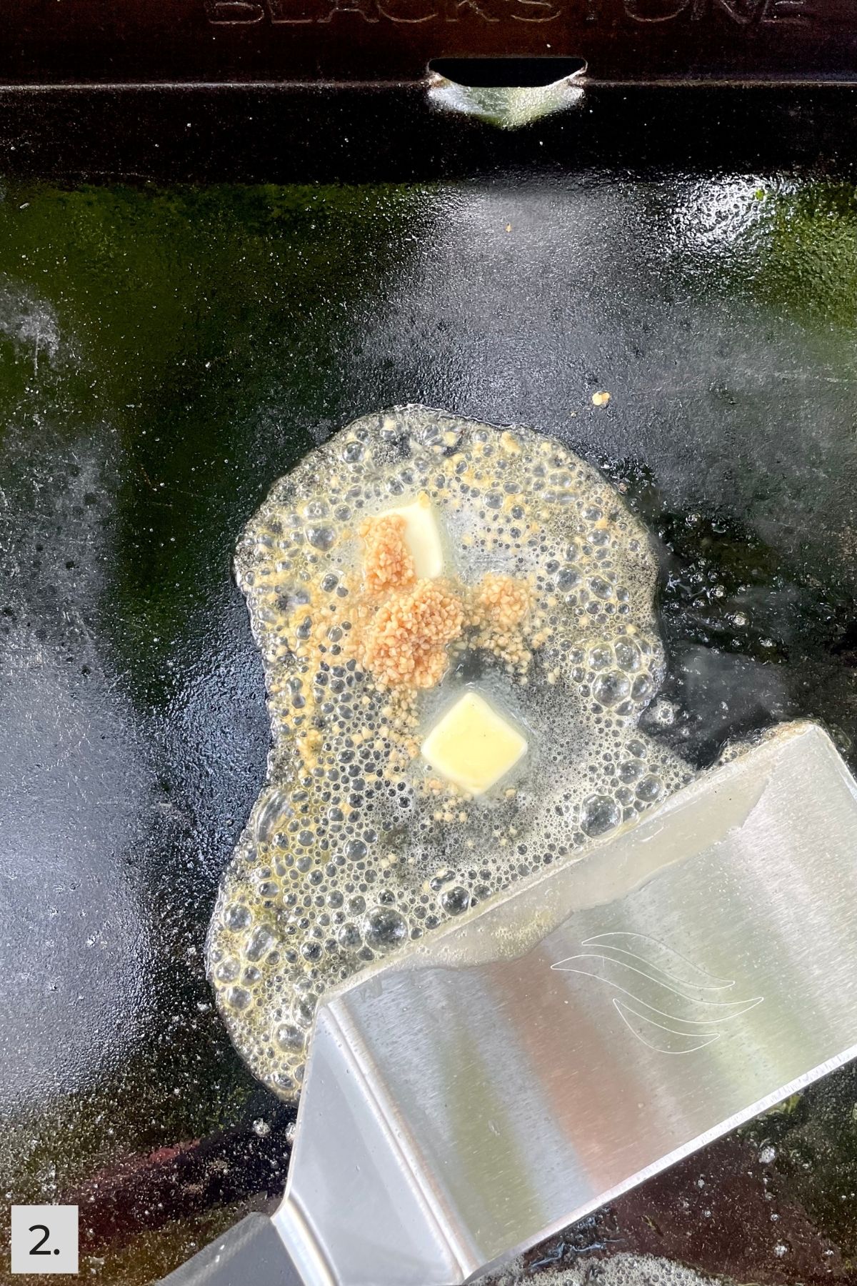 Butter and garlic on flat top Blackstone griddle.