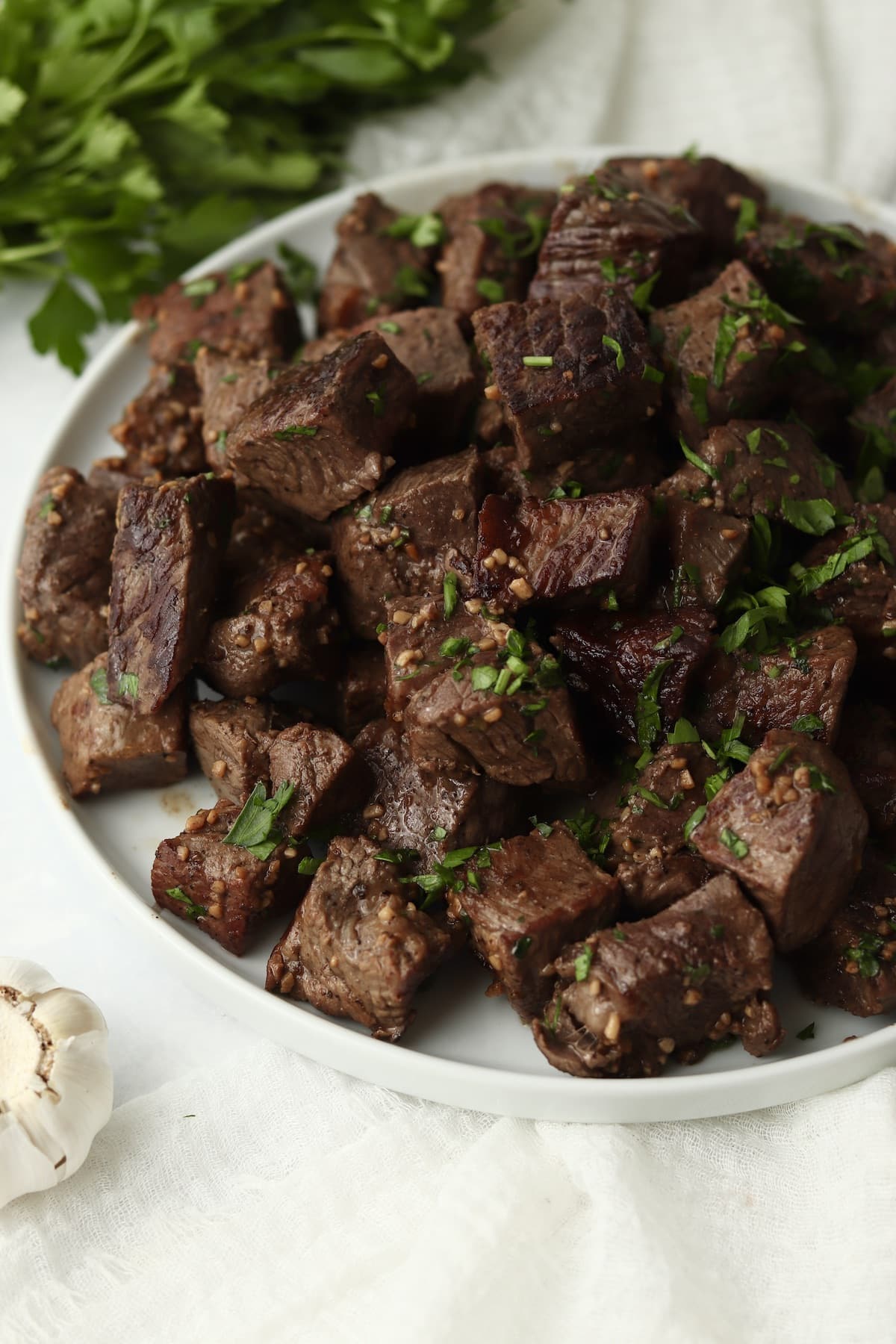 Plate of Blackstone garlic butter steak bites with parsley.