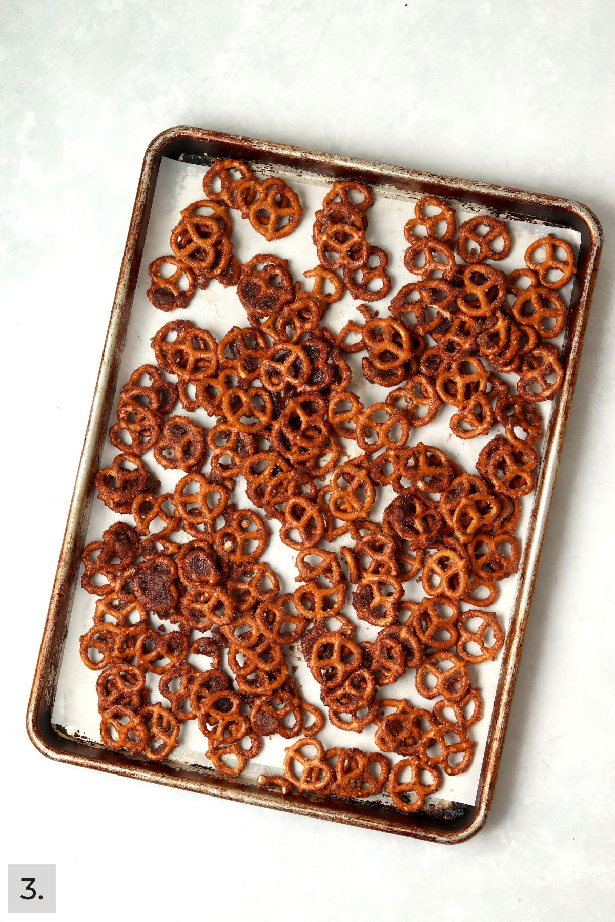 Coated cinnamon sugar pretzels before baking on the baking sheet.