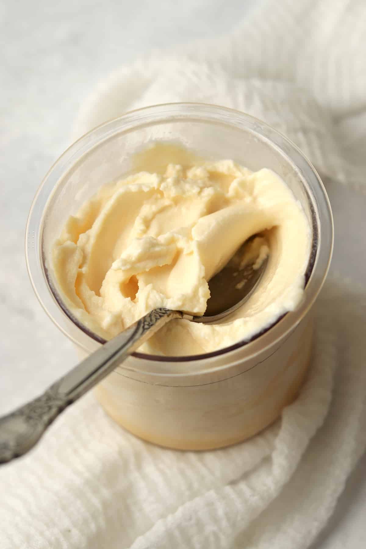 Orange Julius copycat in the Ninja Creami pint container with a spoon.