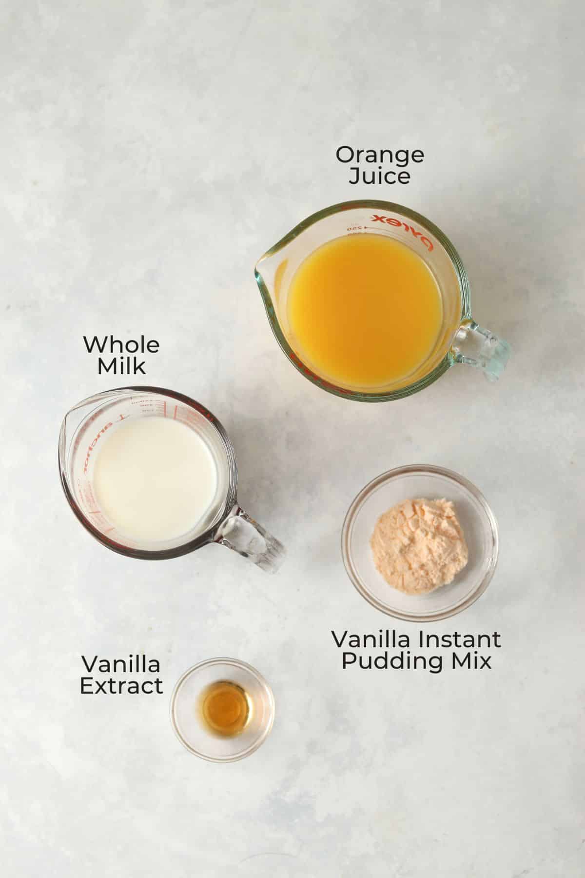 Orange juice, milk, pudding mix, and vanilla extract in prep bowls.