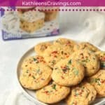 Plate of funfetti cookies with a box of funfetti cake mix in background.