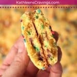 Hand holding a funfetti cake mix cookie that is broken in half.