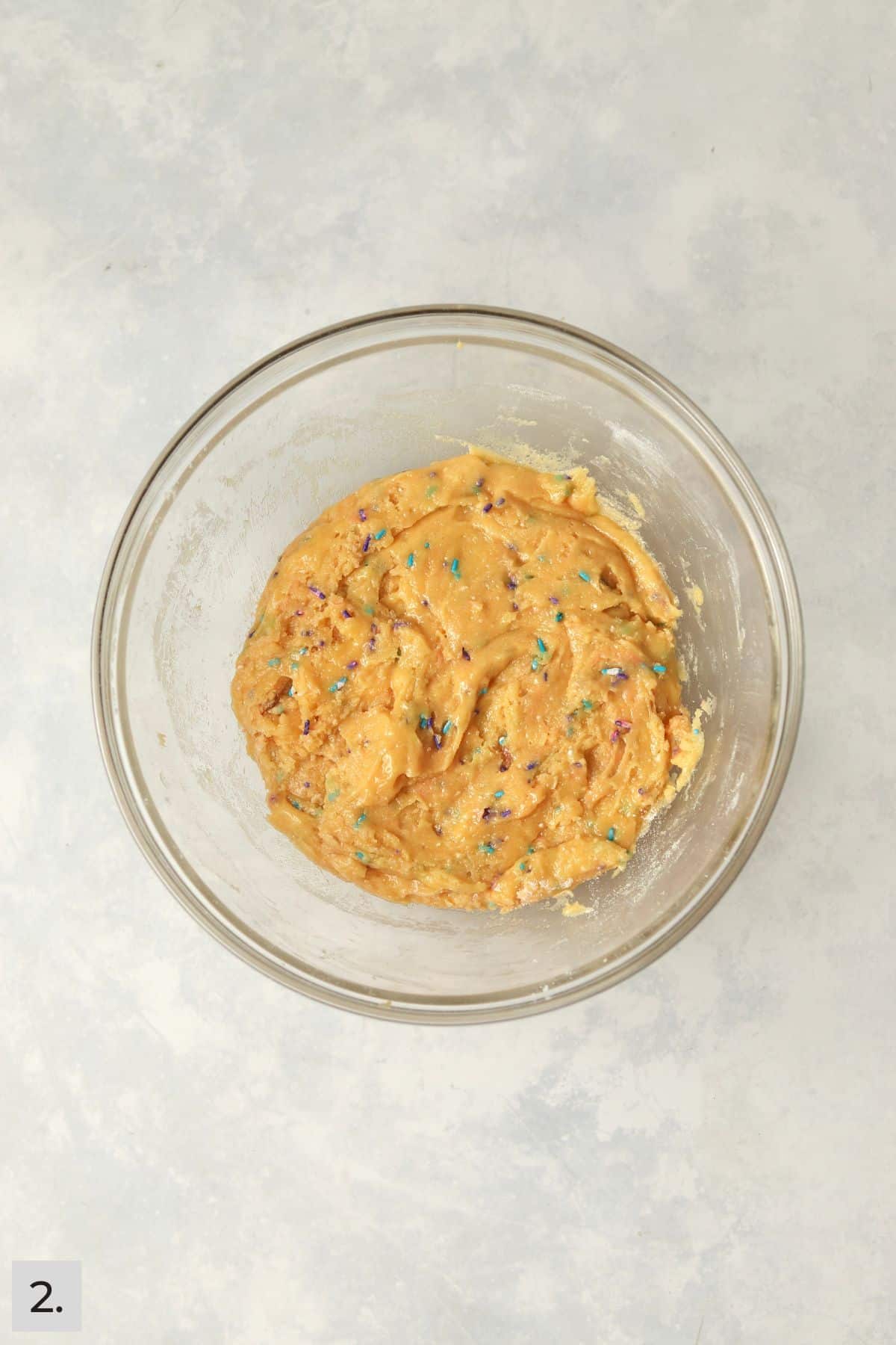 Funfetti cookie dough in glass bowl.