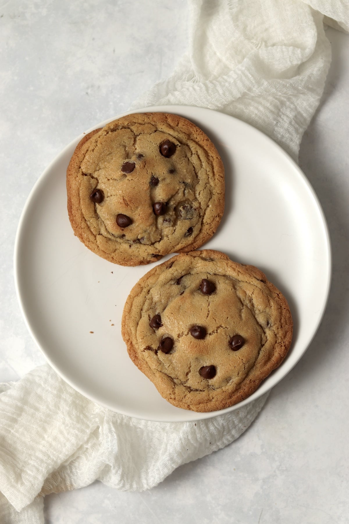 Single serve chocolate chip cookies on a baking sheet.