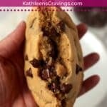 Single serve chocolate chip cookie broken in half and showing the inside.