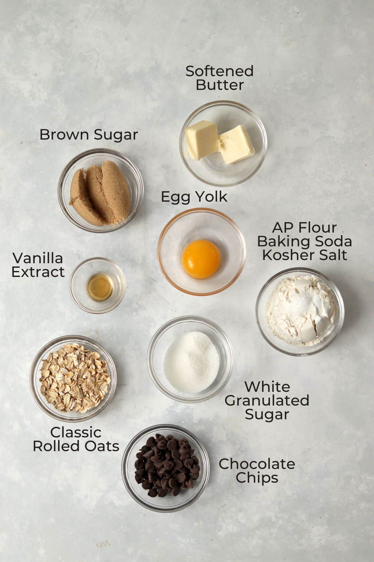 Oatmeal chocolate chip cookie ingredients in small glass prep bowls.