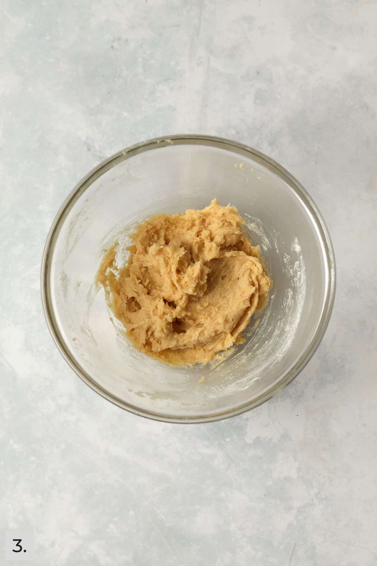 Small batch of sugar cookie dough in a glass bowl.