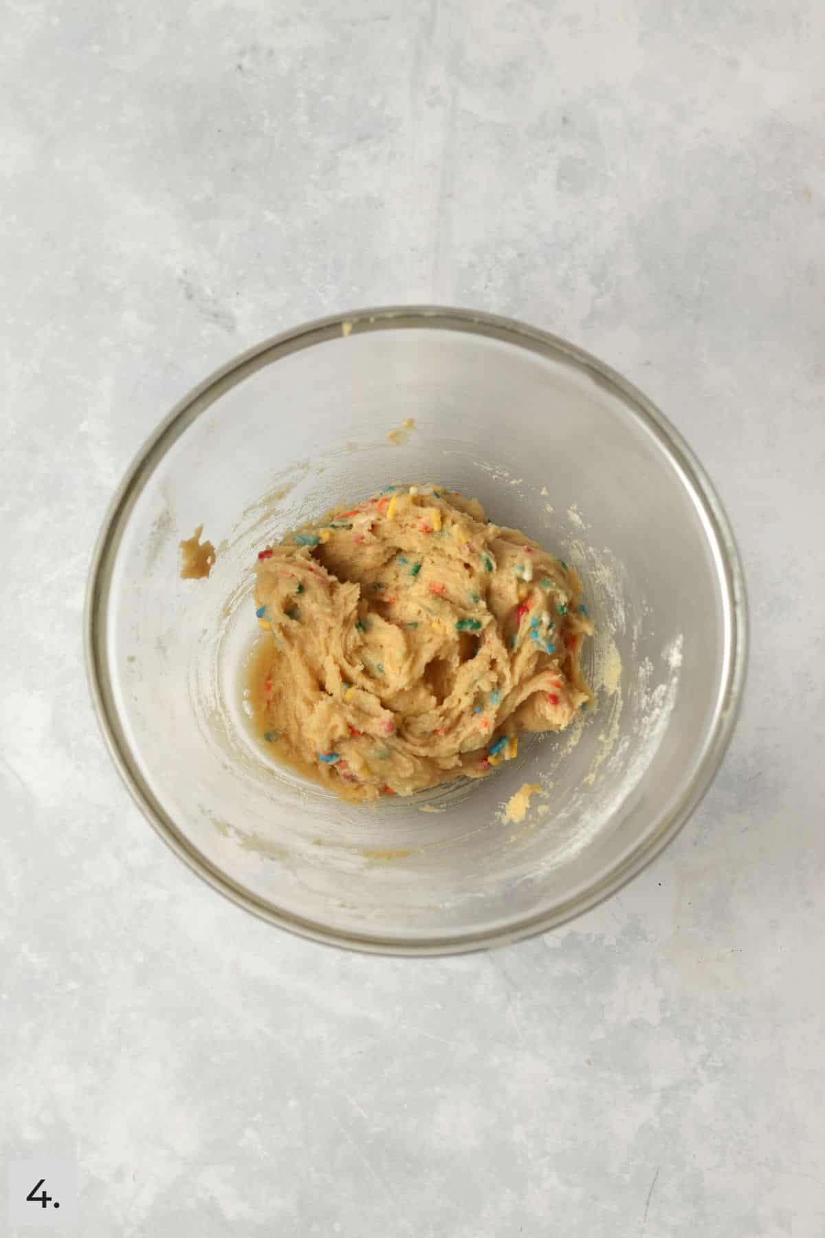 Small batch of sugar cookie with sprinkles in glass bowl.