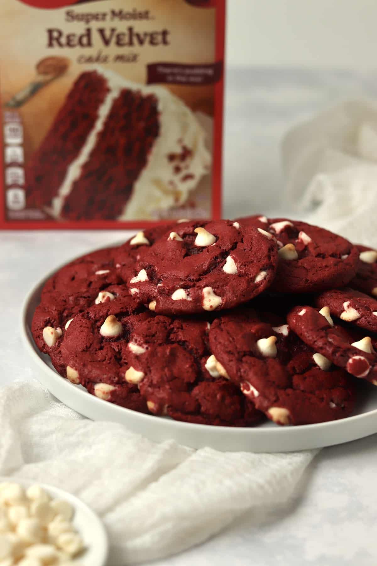 Plate of red velvet cookies with a box of cake mix in background.