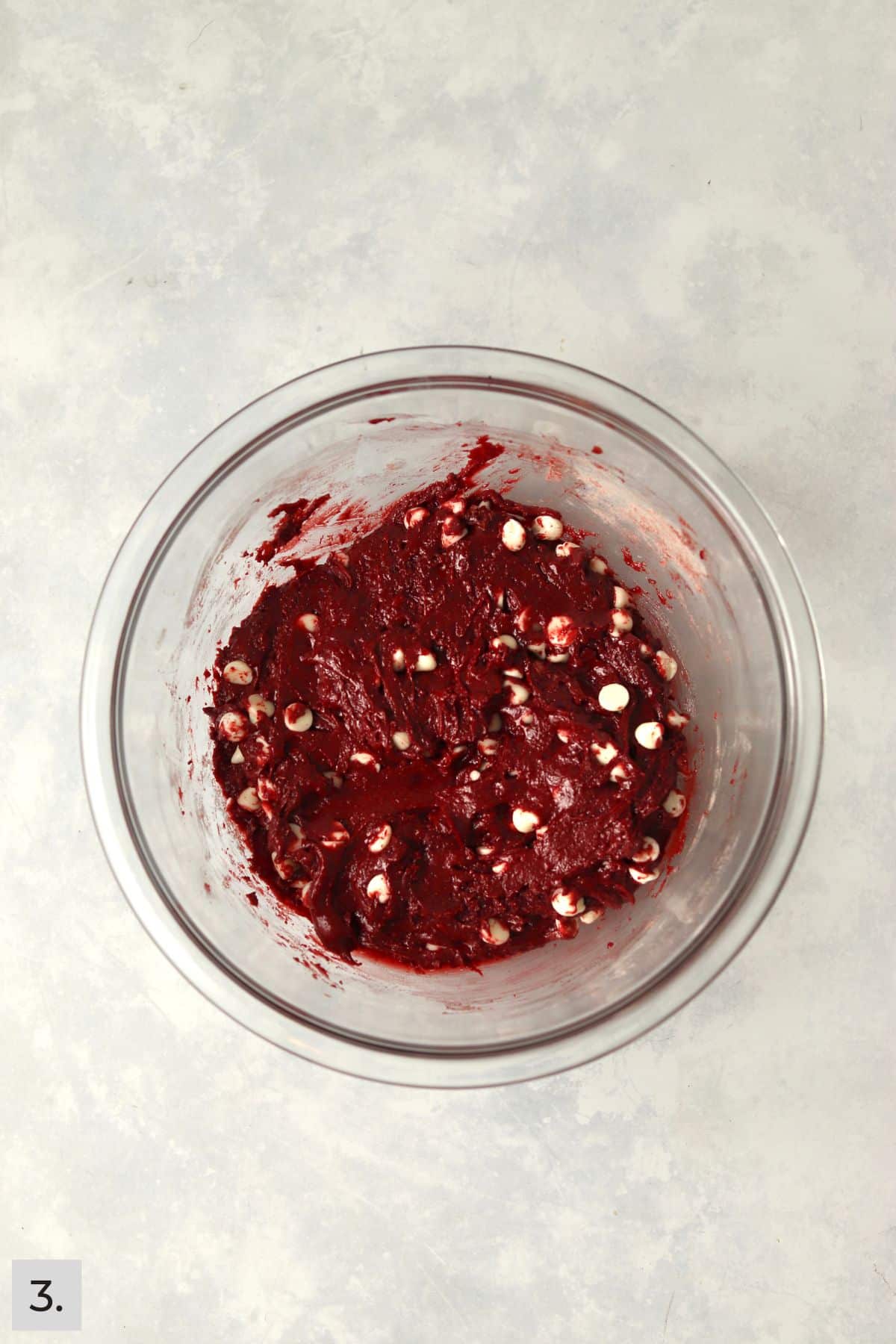 Red Velvet Cake Mix cookie dough in a bowl with white chocolate chips.