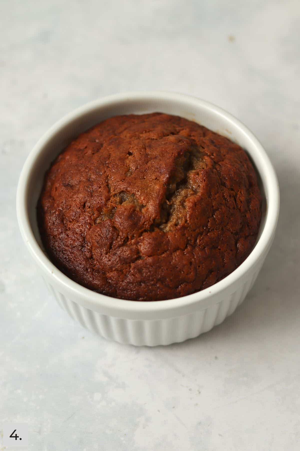 Baked single serve banana bread in a ramekin.