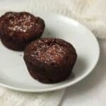 Single serve brownie on a plate dusted with powdered sugar.