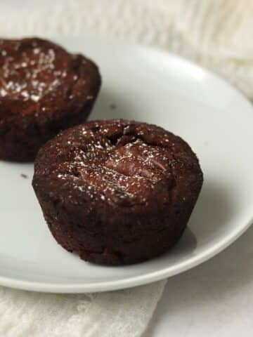 Single serve brownie on a plate dusted with powdered sugar.