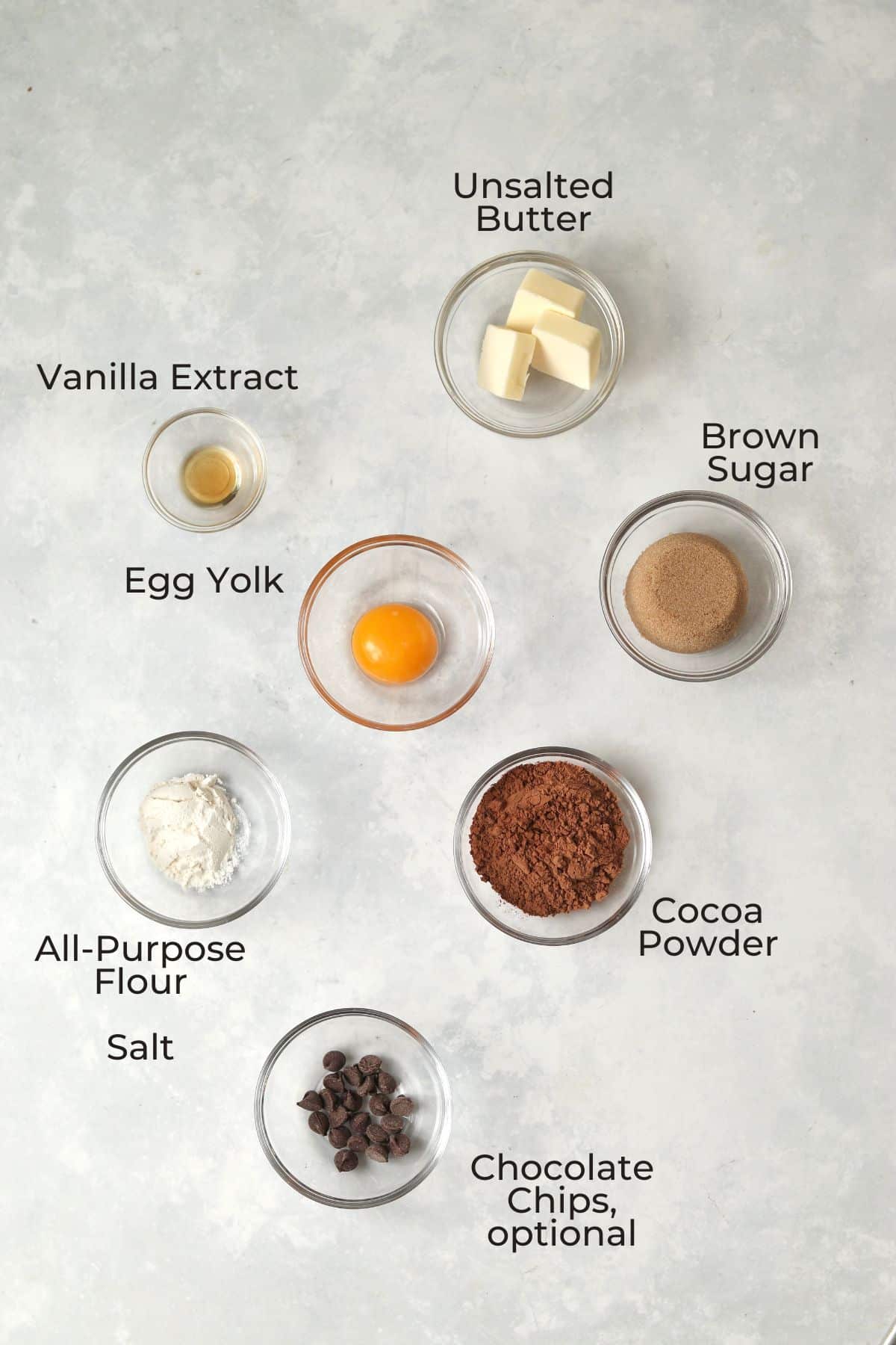 Single serve brownie ingredients in small glass prep bowls.