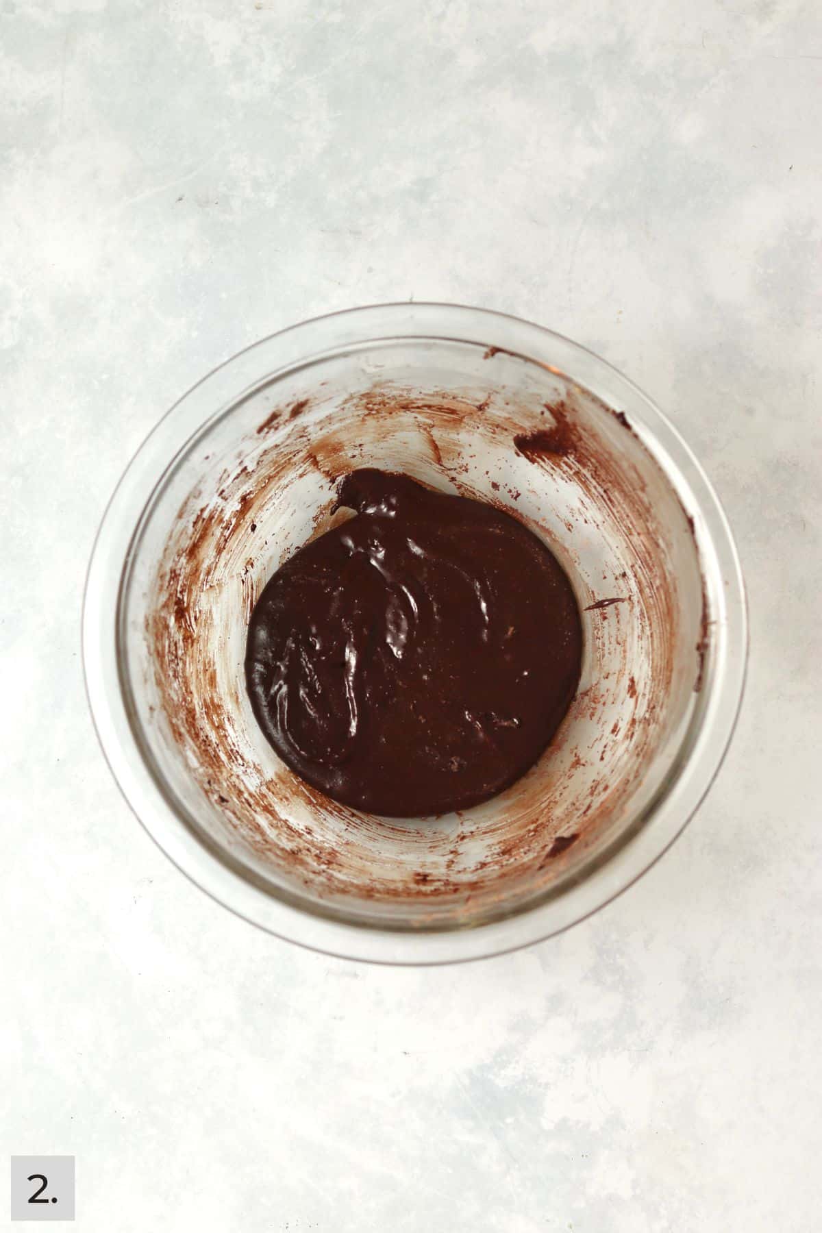 Small batch of brownie batter in a glass bowl.