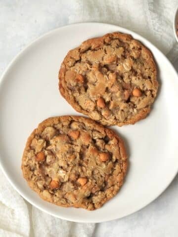 Single serve oatmeal scotchie cookie on a plate with butterscotch chips.