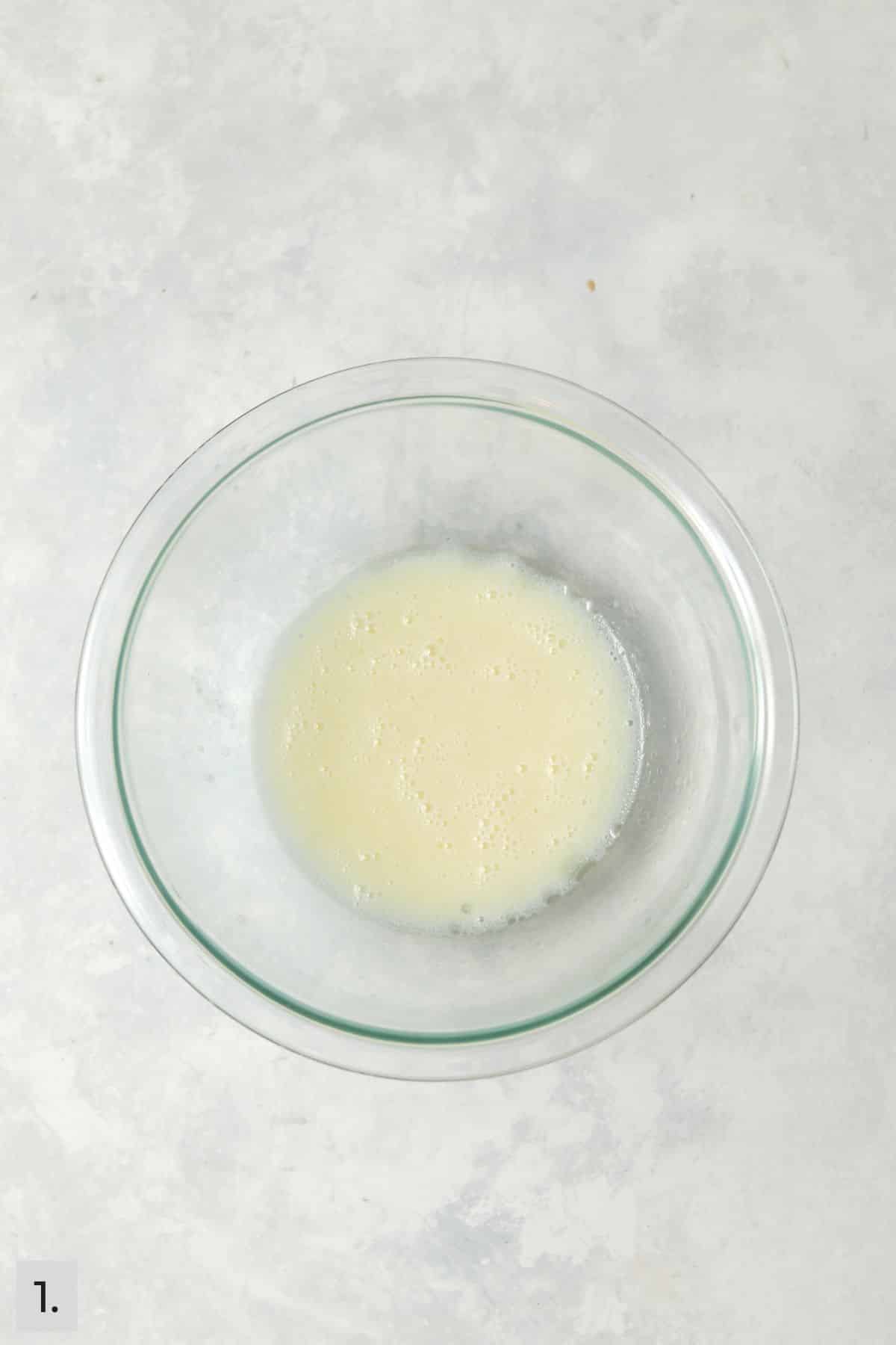 Wet ingredients for the cupcake batter mixed in a bowl.