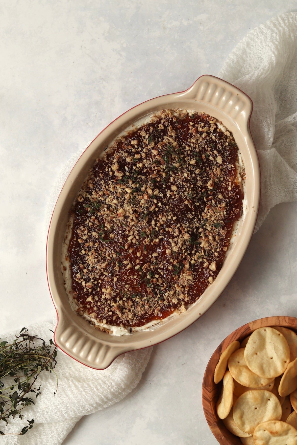 Goat Cheese and Fig Dip in a dish with pita chips and topped with thyme.