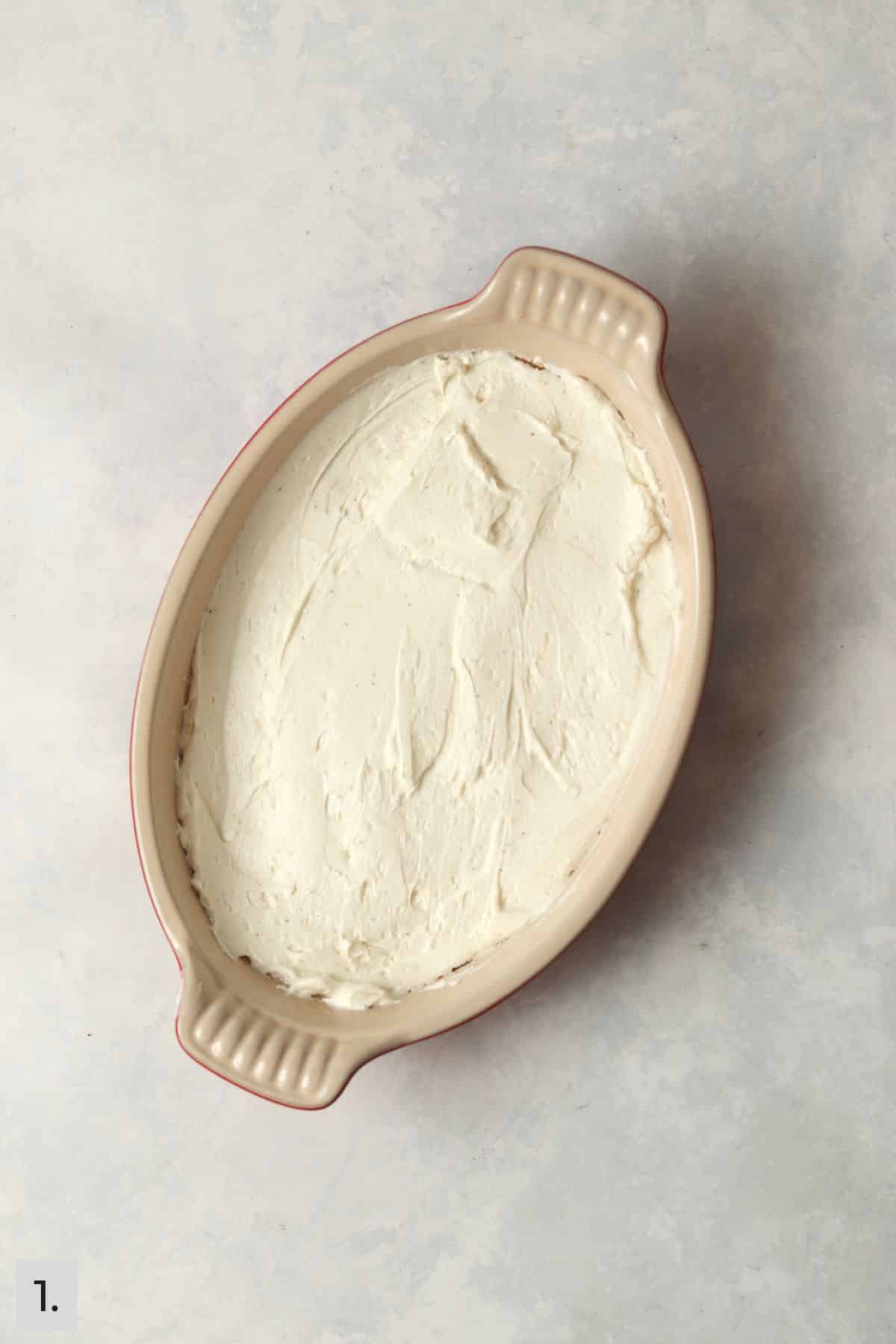 Whipped cream cheese and goat cheese spread in dish.