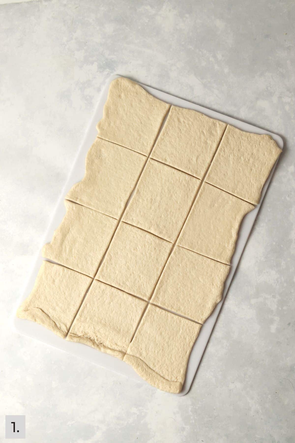 Pizza dough cut into squares.