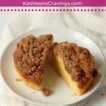 Individual coffee cake with streusel topping on a plate.