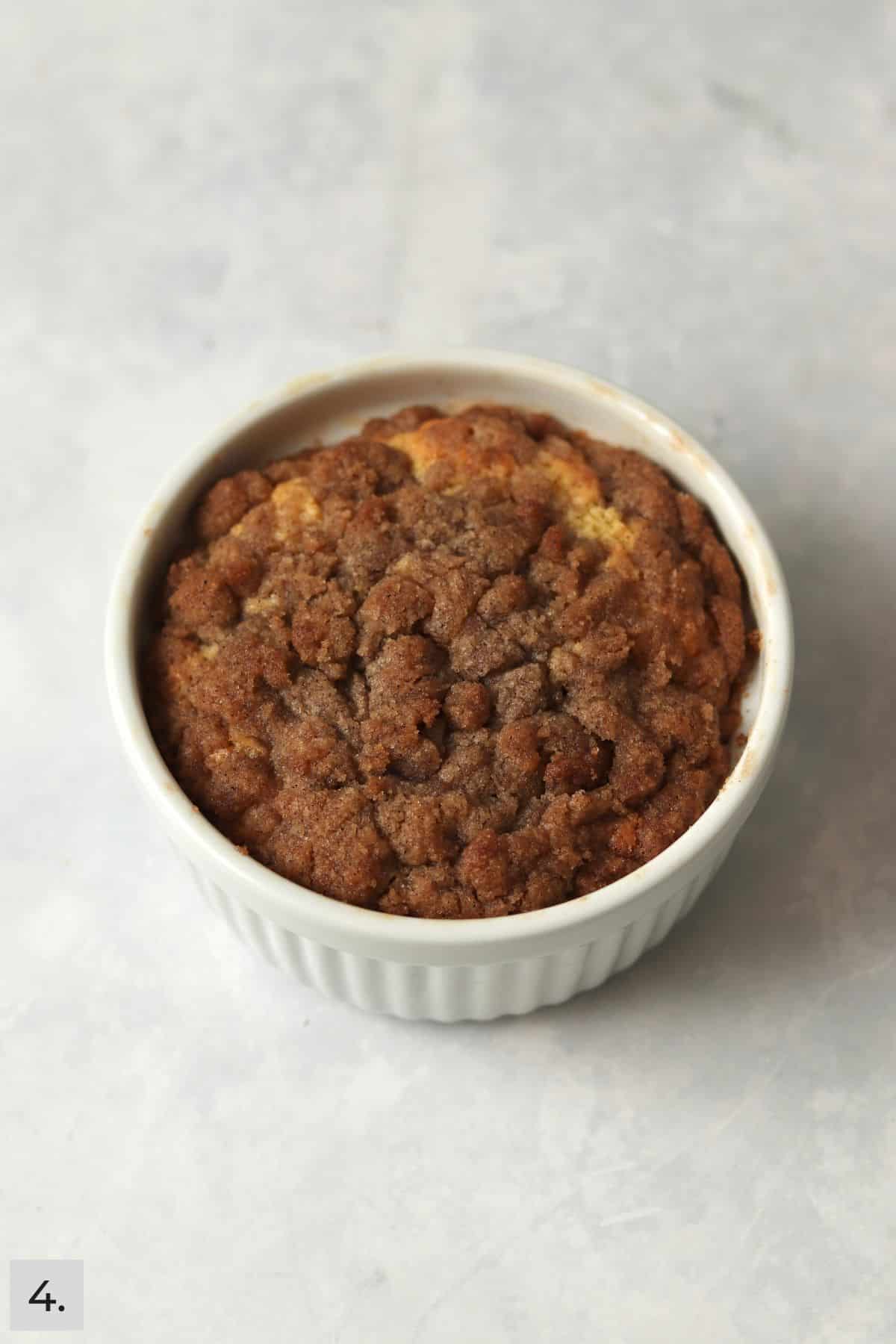 Single serve coffee cake with streusel topping in the ramekin dish.