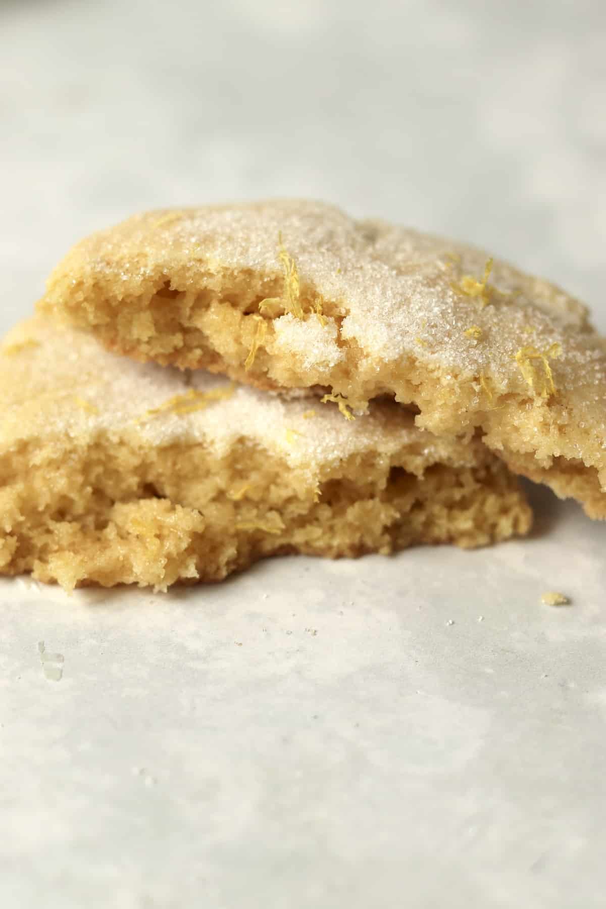 One lemon cookie broken in half to show tender center.