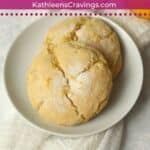 Two lemon sugar cookies on a plate.