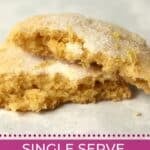 One chewy lemon cookie broken in half to show tender inside.