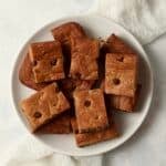 Plate of almond butter chocolate chip cookie bars cut into squares.