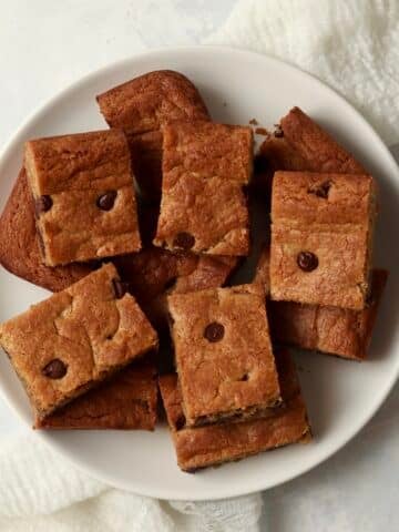 Plate of almond butter chocolate chip cookie bars cut into squares.