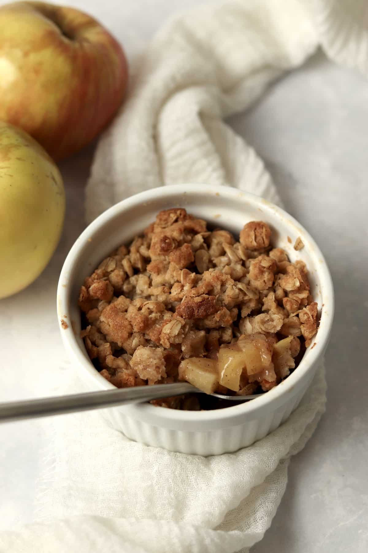 Single serve apple crisp in a ramekin.