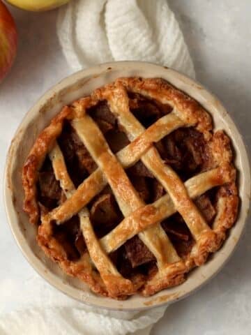 Single serve apple pie in a mini 5 inch pie dish after baking.