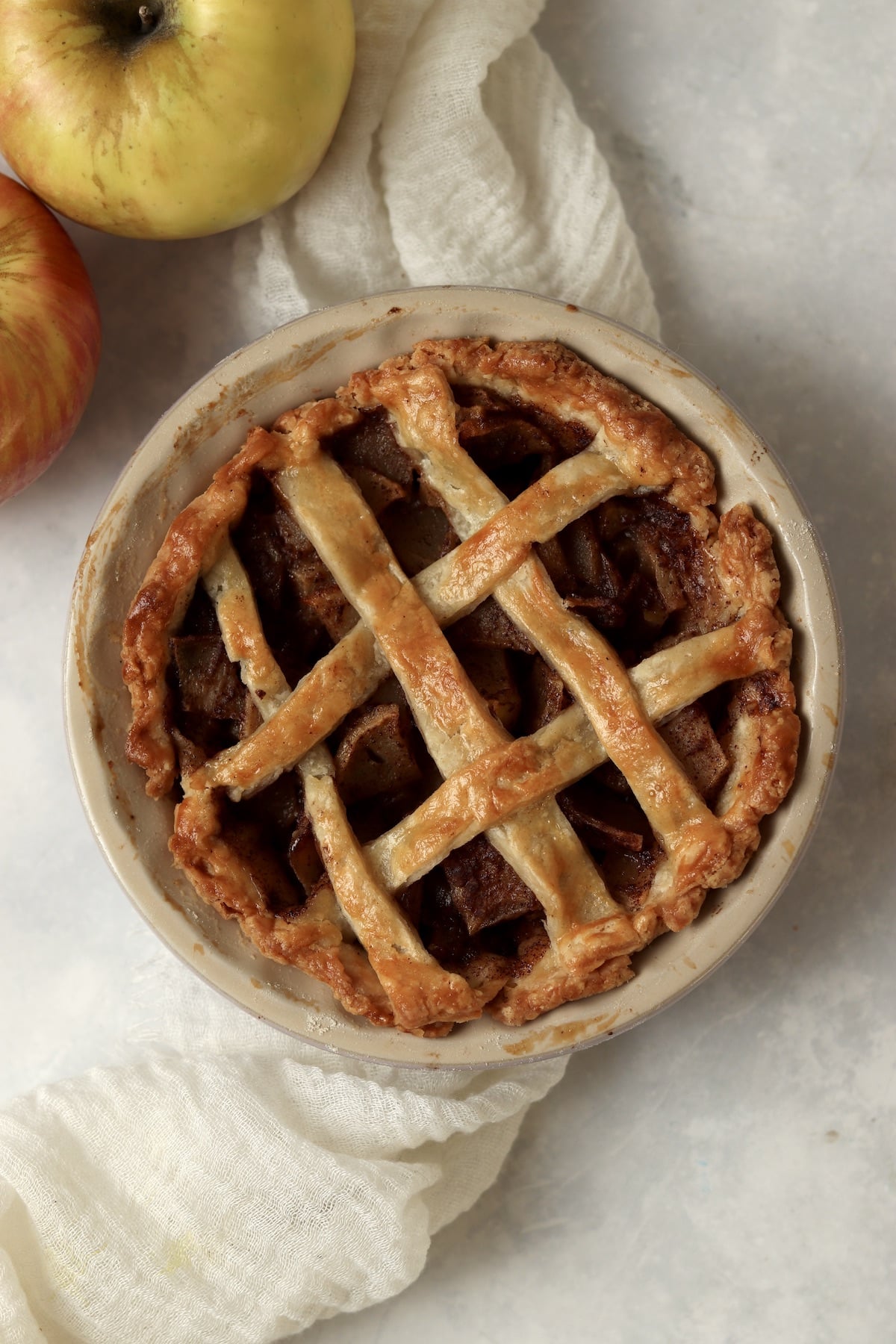 Single serve apple pie in a mini 5 inch pie dish after baking.