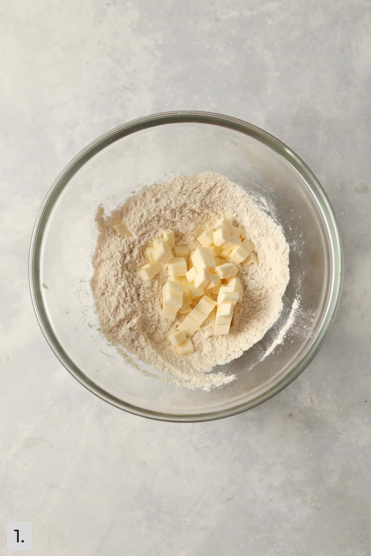 Cubed butter added to flour and sugar for pie crust.
