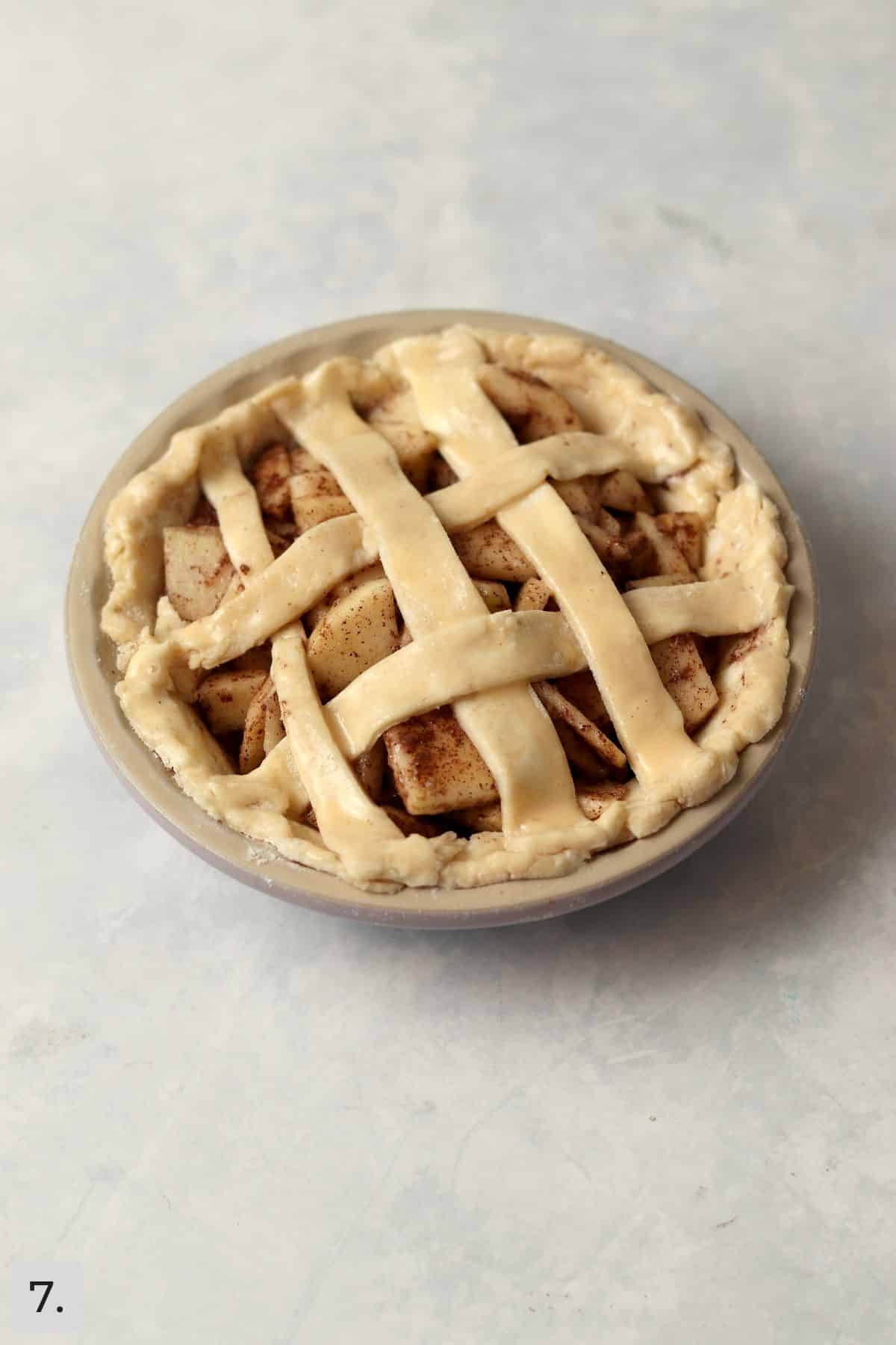 Unbaked small apple pie in the 5 inch pie dish.