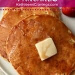 Pancakes for one on a plate with maple syrup and berries.