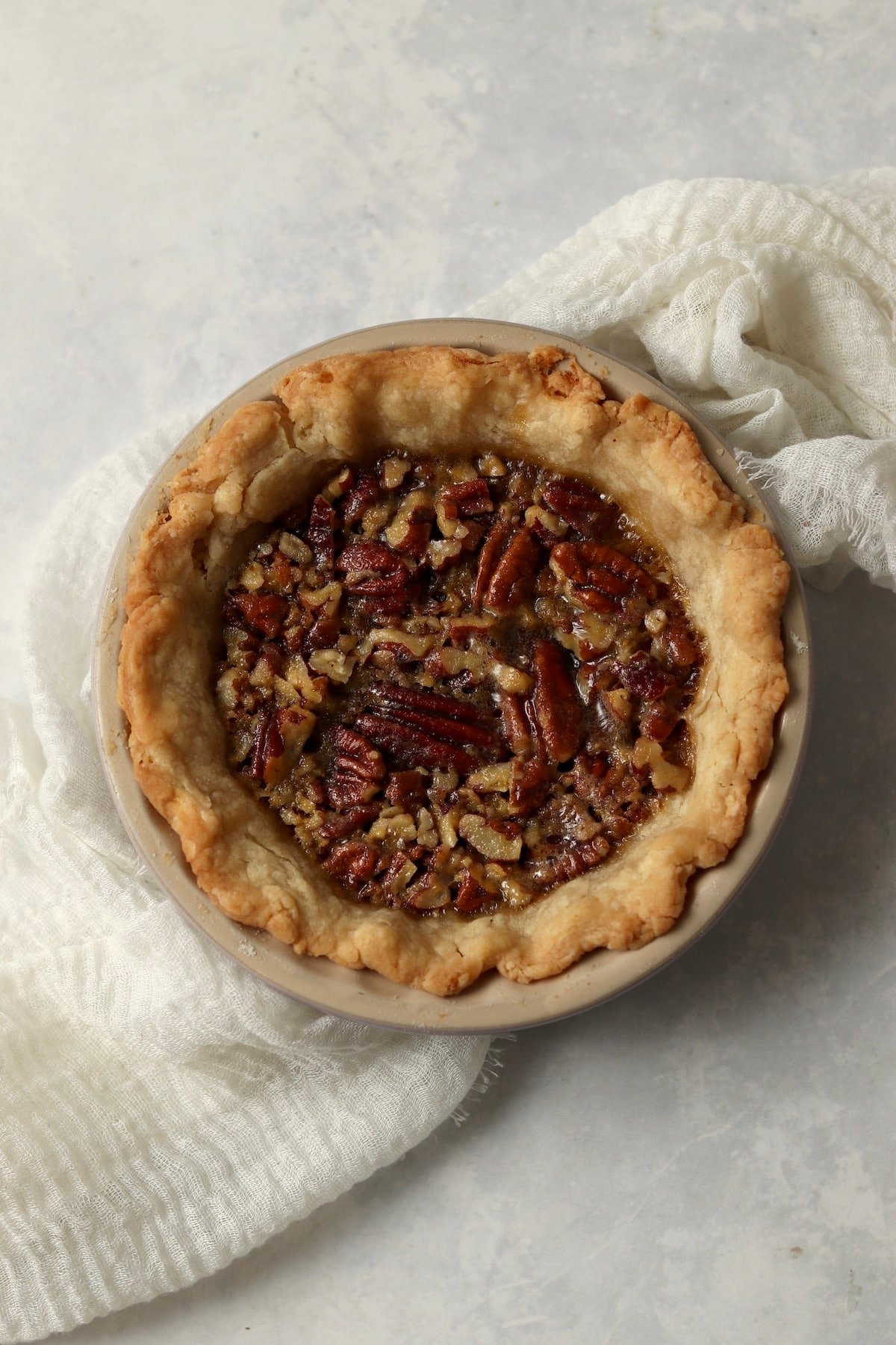 Single serve pecan pie in a mini 5 inch pie dish after baking.