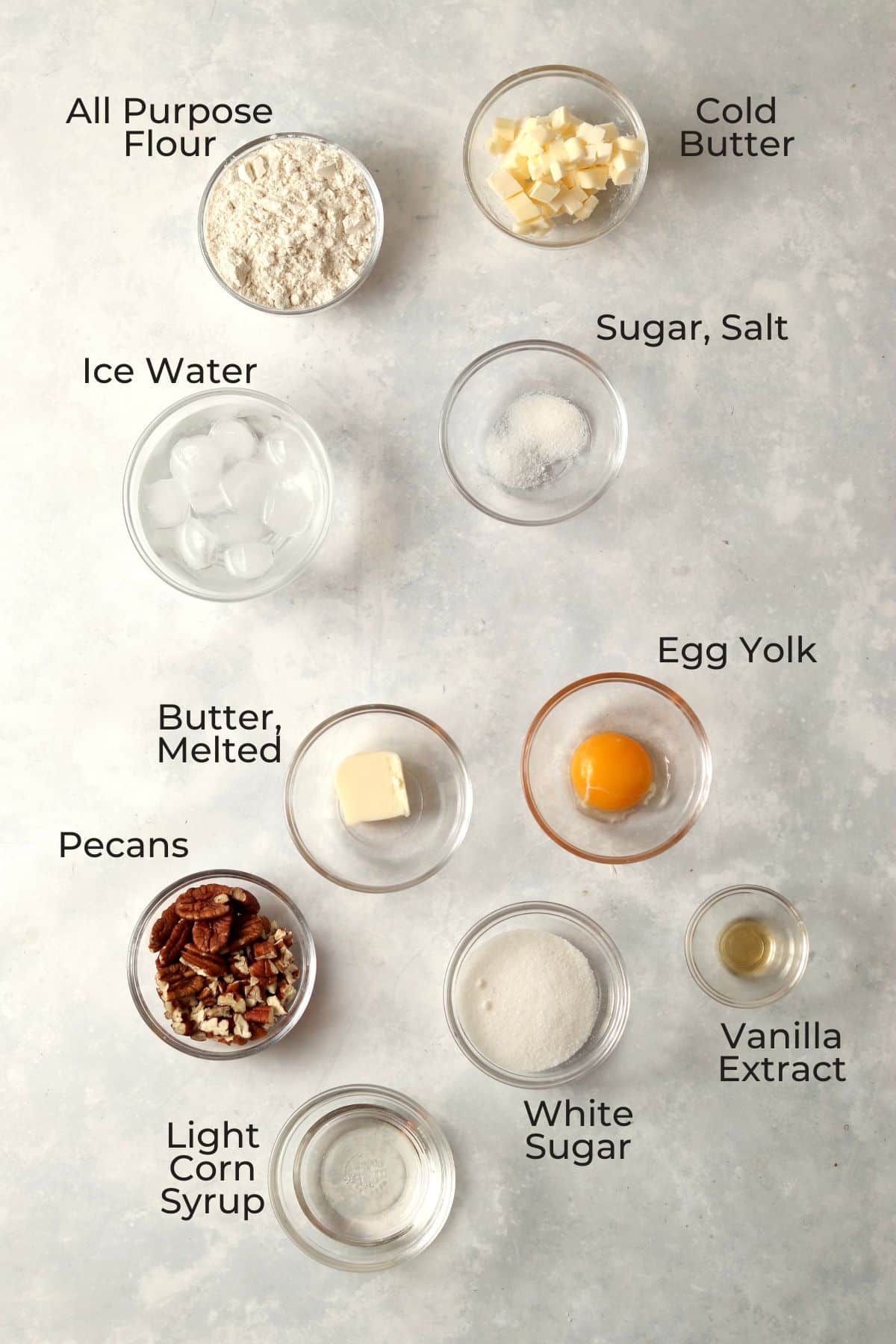 Small batch pecan pie ingredients in small glass prep bowls.