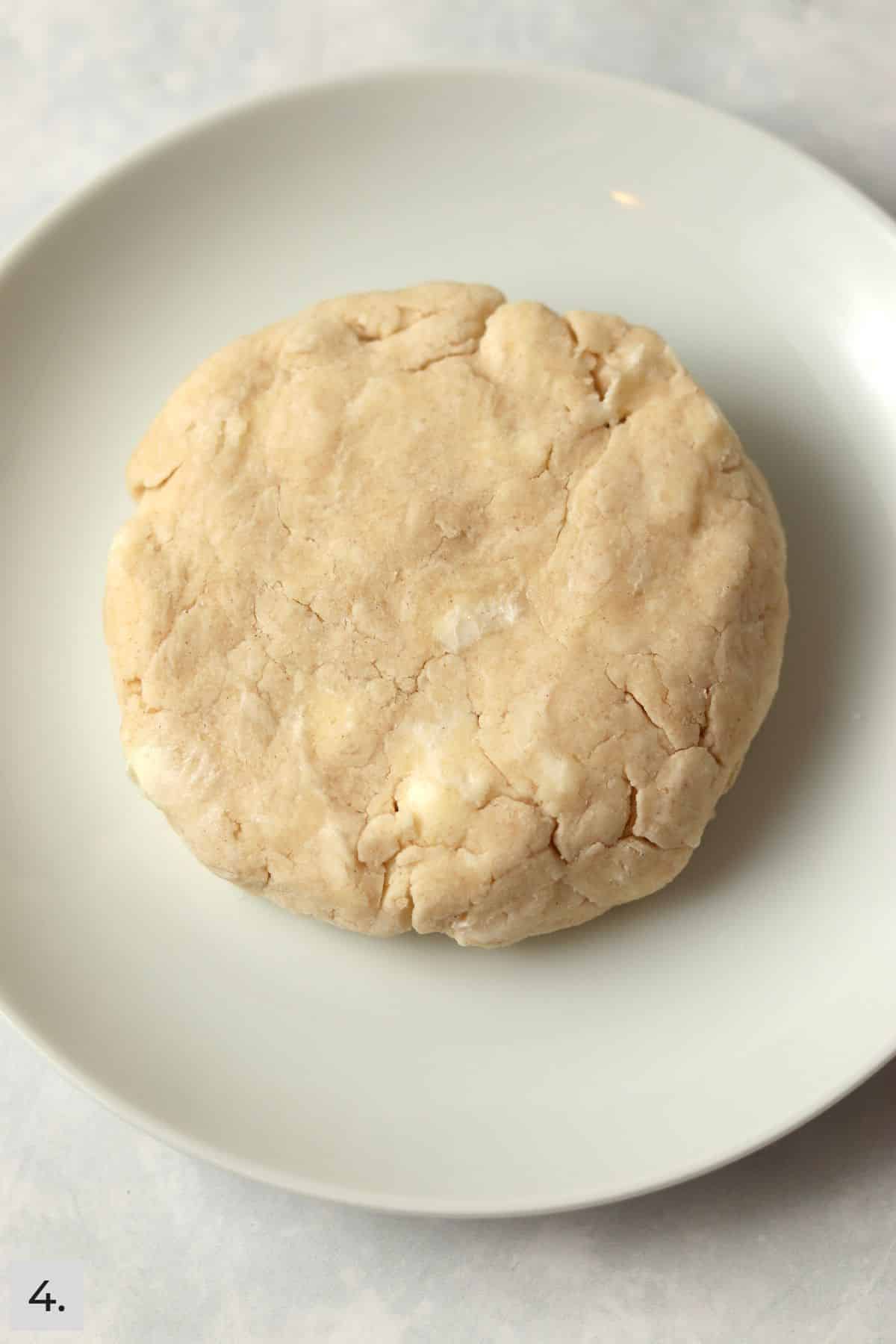 Small disc of pie dough with visible pieces of butter.