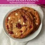 Two white chocolate raspberry cookies on a plate.