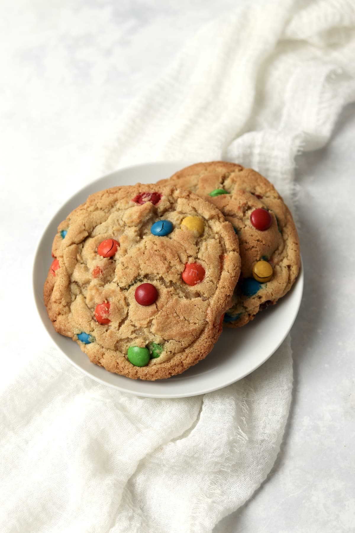Single serve M&M cookies on a small plate.