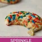 Sprinkle cookie with bite taken out.