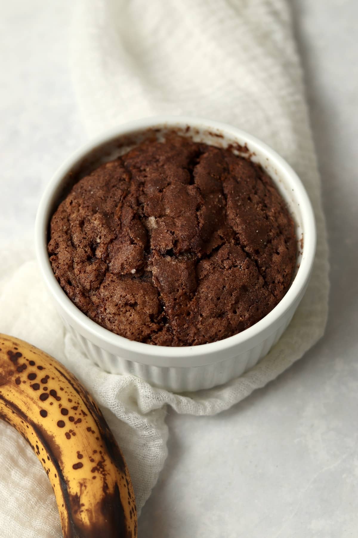 Baked single serve cinnamon swirl banana bread in a ramekin.